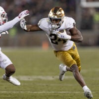 Nov 29, 2025; Stanford, California, USA; Notre Dame Fighting Irish running back Jadarian Price (24) runs with the football against Stanford Cardinal safety Darrius Davis (29) during the first quarter at Stanford Stadium. Mandatory Credit: Stan Szeto-Imagn Images
