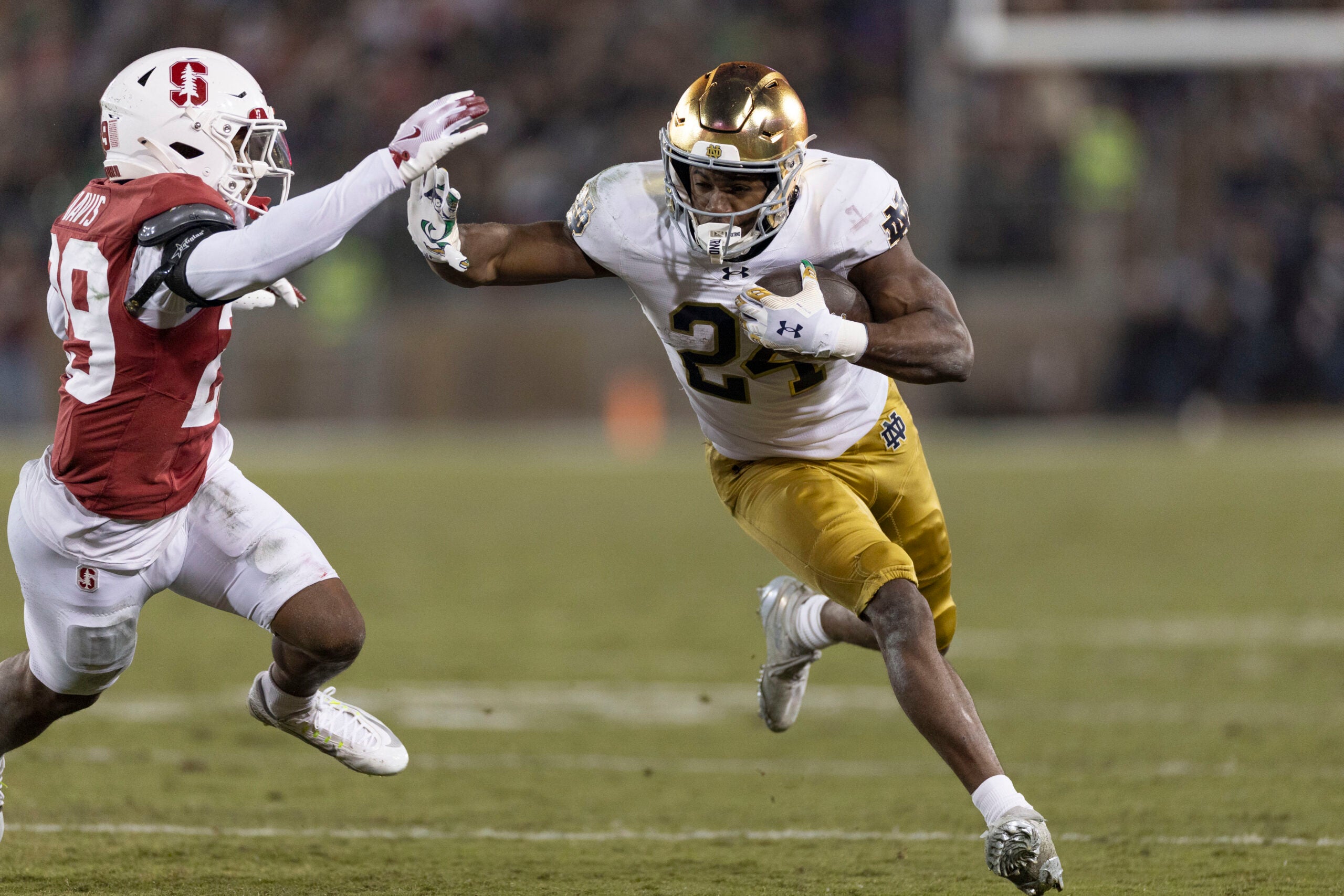 Nov 29, 2025; Stanford, California, USA; Notre Dame Fighting Irish running back Jadarian Price (24) runs with the football against Stanford Cardinal safety Darrius Davis (29) during the first quarter at Stanford Stadium. Mandatory Credit: Stan Szeto-Imagn Images