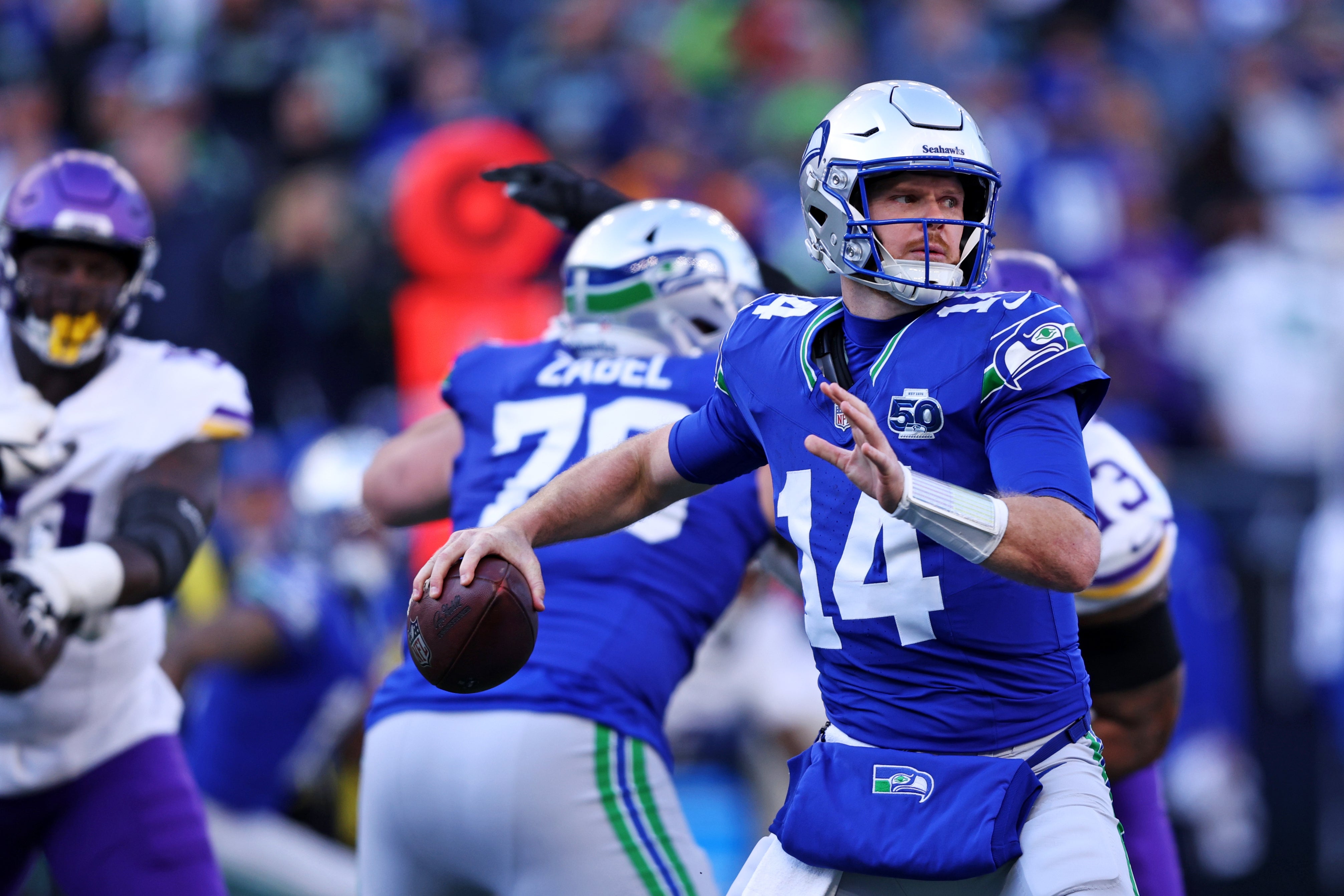 Nov 30, 2025; Seattle, Washington, USA; Seattle Seahawks quarterback Sam Darnold (14) drops back to make a pass during the second half against the Minnesota Vikings at Lumen Field.