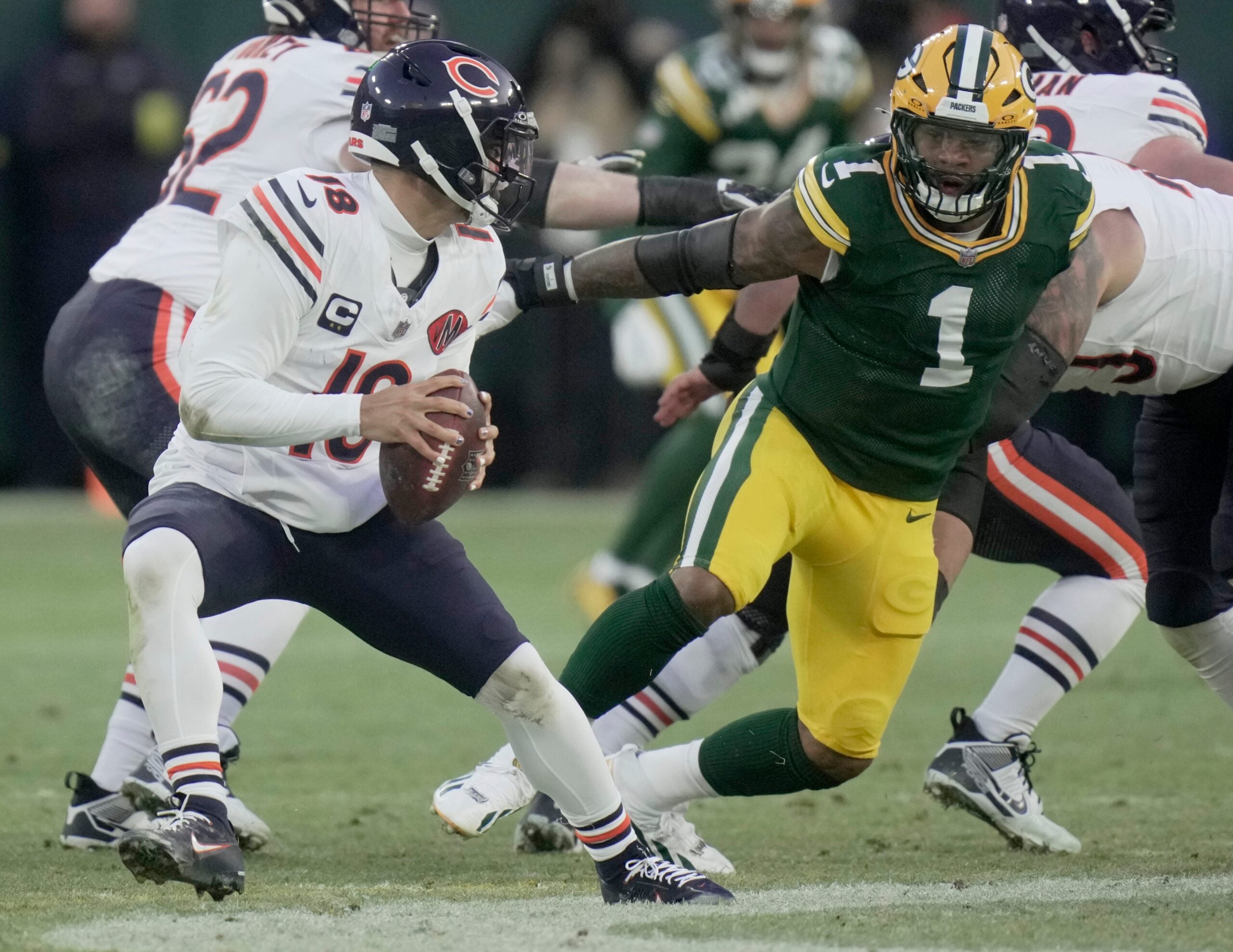Green Bay Packers defensive end Micah Parsons (1) pressures Chicago Bears quarterback Caleb Williams (18) during the first quarter of their game Sunday, December 7, 2025 at Lambeau Field in Green Bay, Wisconsin.