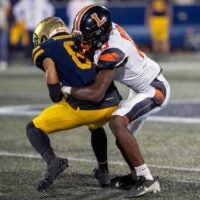 Lakeland's Jordan Young tackles St. Thomas Aquinas' Julius Jones on Thursday night at Pitbull Stadium in the 2025 FHSAA Class 5A State Football Finals.