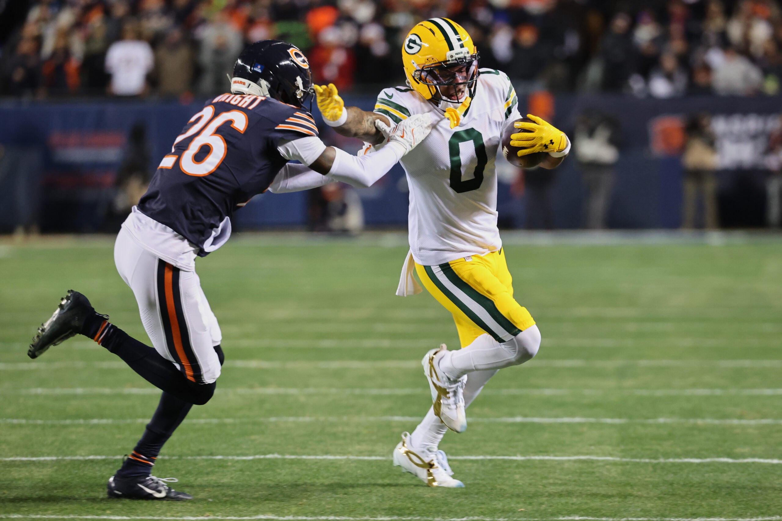 Dec 20, 2025; Chicago, Illinois, USA; Green Bay Packers wide receiver Matthew Golden (0) runs with the ball against Chicago Bears cornerback Nahshon Wright (26) during the first quarter at Soldier Field.