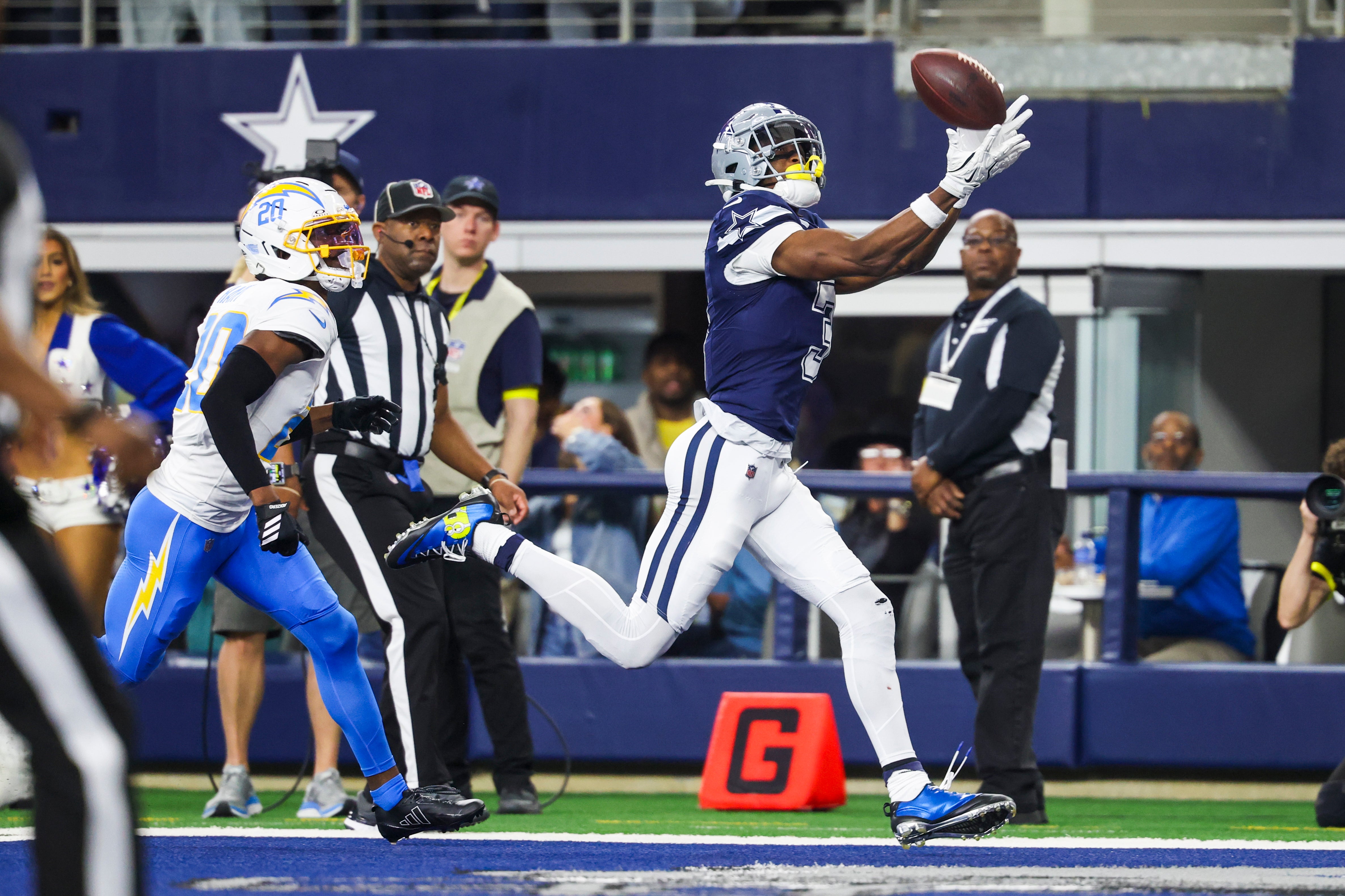 Dec 21, 2025; Arlington, Texas, USA; Dallas Cowboys wide receiver George Pickens (3) catches a touchdown pass against Los Angeles Chargers cornerback Cam Hart (20) during the second quarter at AT&T Stadium.