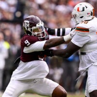 Dec 20, 2025; College Station, TX, USA; Miami Hurricanes offensive lineman Markel Bell (70) blocks Texas A&M Aggies defensive end Cashius Howell (9) during the game between the Aggies and the Hurricanes at Kyle Field.