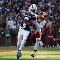 Dec 25, 2025; Landover, Maryland, USA; Dallas Cowboys wide receiver George Pickens (3) carries the ball as Washington Commanders cornerback Noah Igbinoghene (6) defends during the first half at Northwest Stadium.
