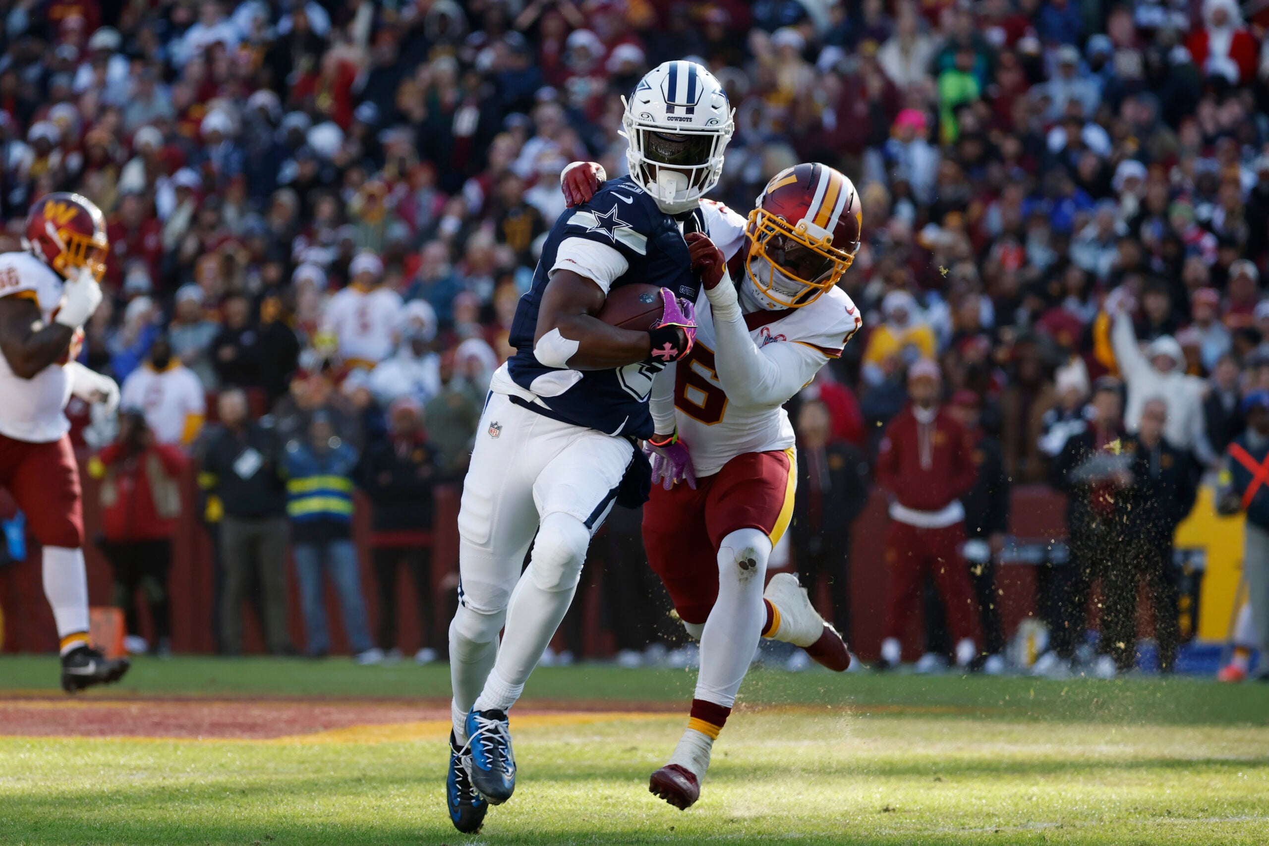Dec 25, 2025; Landover, Maryland, USA; Dallas Cowboys wide receiver George Pickens (3) carries the ball as Washington Commanders cornerback Noah Igbinoghene (6) defends during the first half at Northwest Stadium.