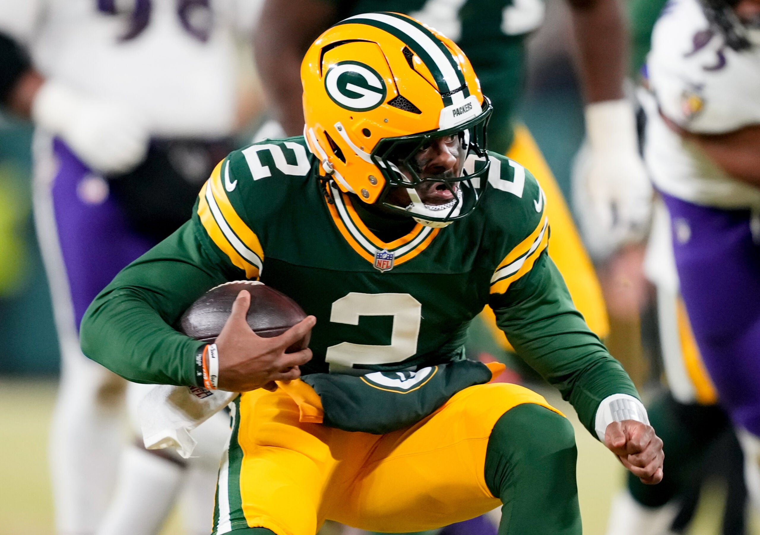 Dec 27, 2025; Green Bay, Wisconsin, USA; Green Bay Packers quarterback Malik Willis (2) runs the ball during the third quarter against the Baltimore Ravens at Lambeau Field.
