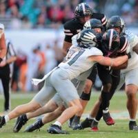 Jan 1, 2026; Miami Gardens, FL, USA; Texas Tech Red Raiders running back J'Koby Williams (20) is tackled by Oregon Ducks defensive back Dillon Thieneman (31) during the second half of the 2025 Orange Bowl and quarterfinal game of the College Football Playoff at Hard Rock Stadium.