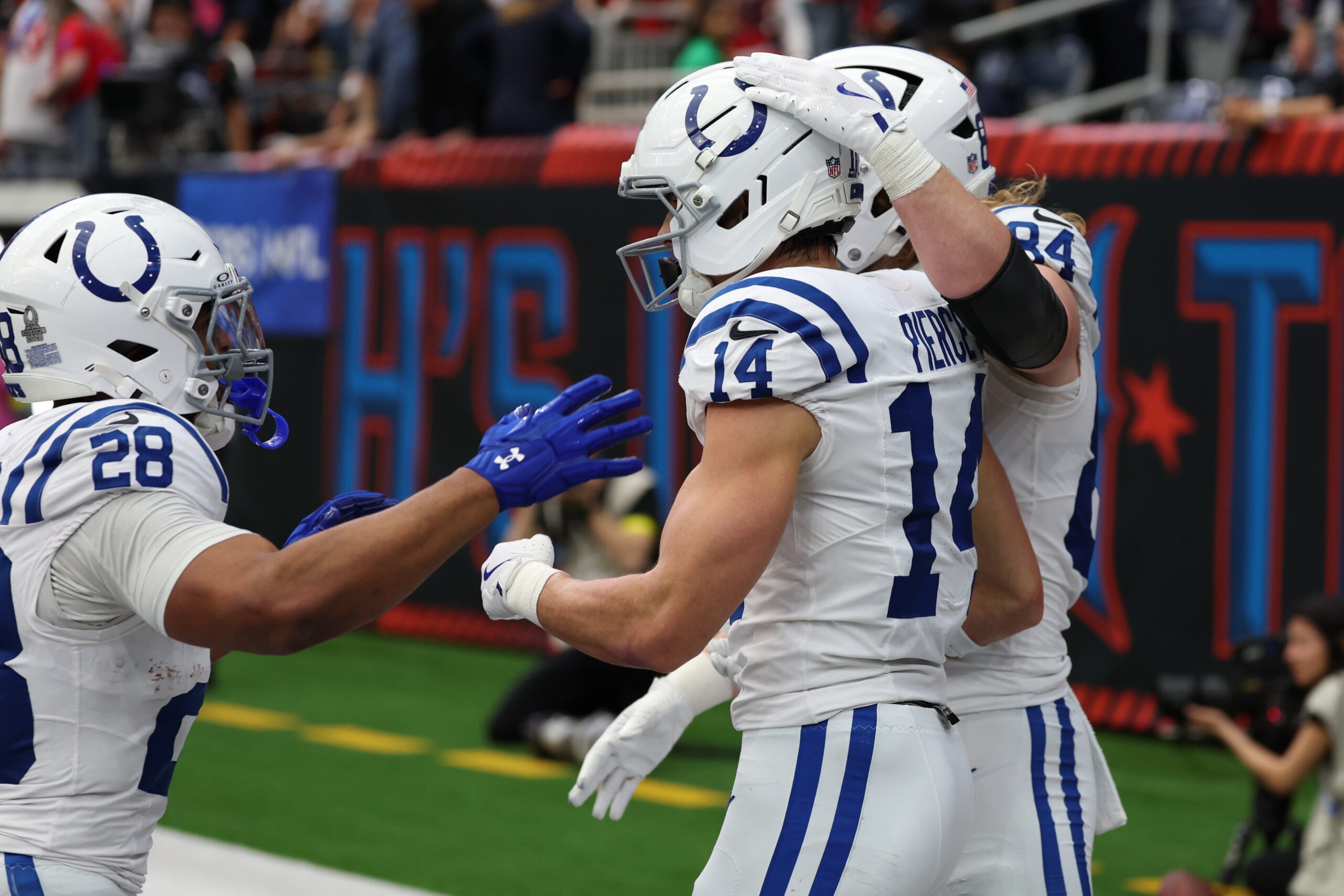 Colts RB Jonathan Taylor and TE Tyler Warren celebrate with WR Alec Pierce after a touchdown catch