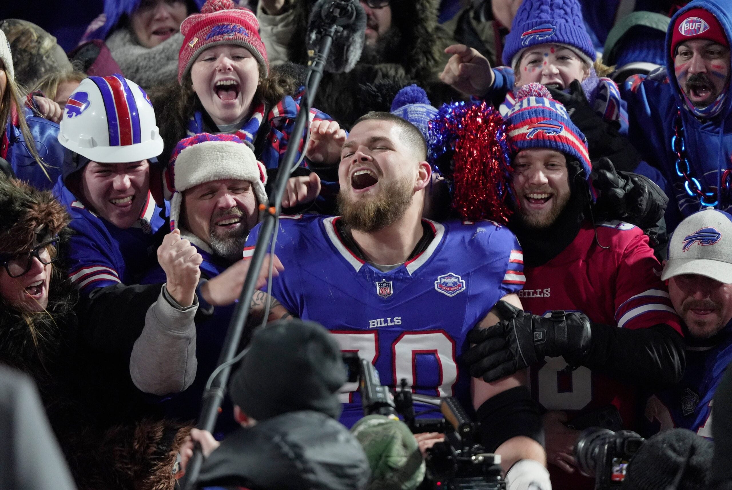 Buffalo Bills offensive tackle Alec Anderson jumps into the fans and sits with them after the game and while a video of game memories at Highmark Stadium played on the jumbotron. The Bills had their last home game at Highmark Stadium in Orchard Park on Jan. 4, 2026 against the JEts and won.