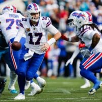Buffalo Bills quarterback Josh Allen (17) hands off to Buffalo Bills running back James Cook III (4) during the first quarter in an NFL football AFC Wild Card playoff matchup, Sunday, Jan. 11, 2026, in Jacksonville, Fla. Bills lead 10-7 at the half over the Jaguars.
