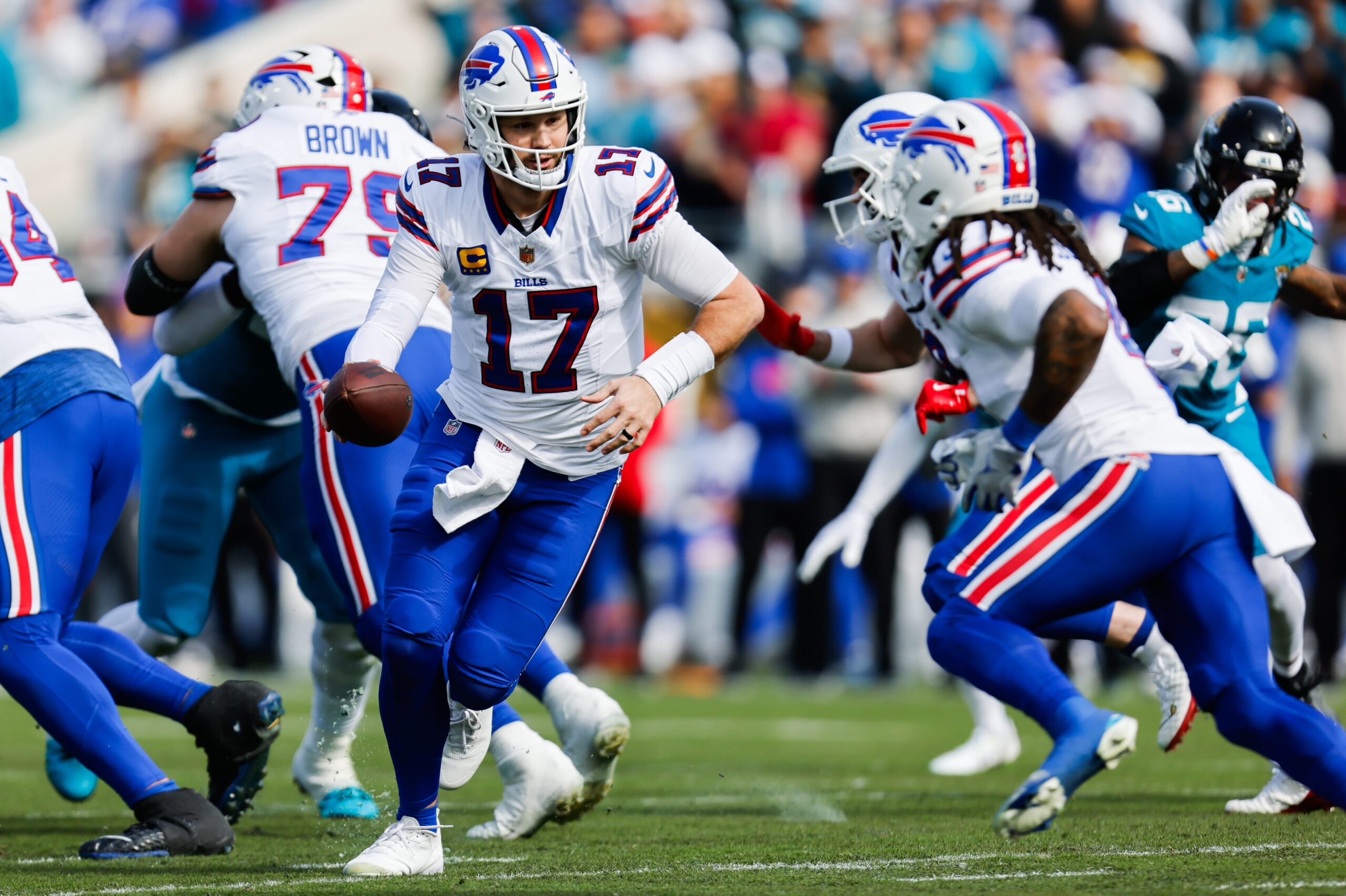 Buffalo Bills quarterback Josh Allen (17) hands off to Buffalo Bills running back James Cook III (4) during the first quarter in an NFL football AFC Wild Card playoff matchup, Sunday, Jan. 11, 2026, in Jacksonville, Fla. Bills lead 10-7 at the half over the Jaguars.