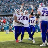 Buffalo Bills center Connor McGovern (66) celebrates a touchdown from Buffalo Bills quarterback Josh Allen (17), not shown, during the fourth quarter of an NFL football AFC Wild Card playoff matchup, Sunday, Jan. 11, 2026, in Jacksonville, Fla. The Bills defeated the Jaguars 27-24.