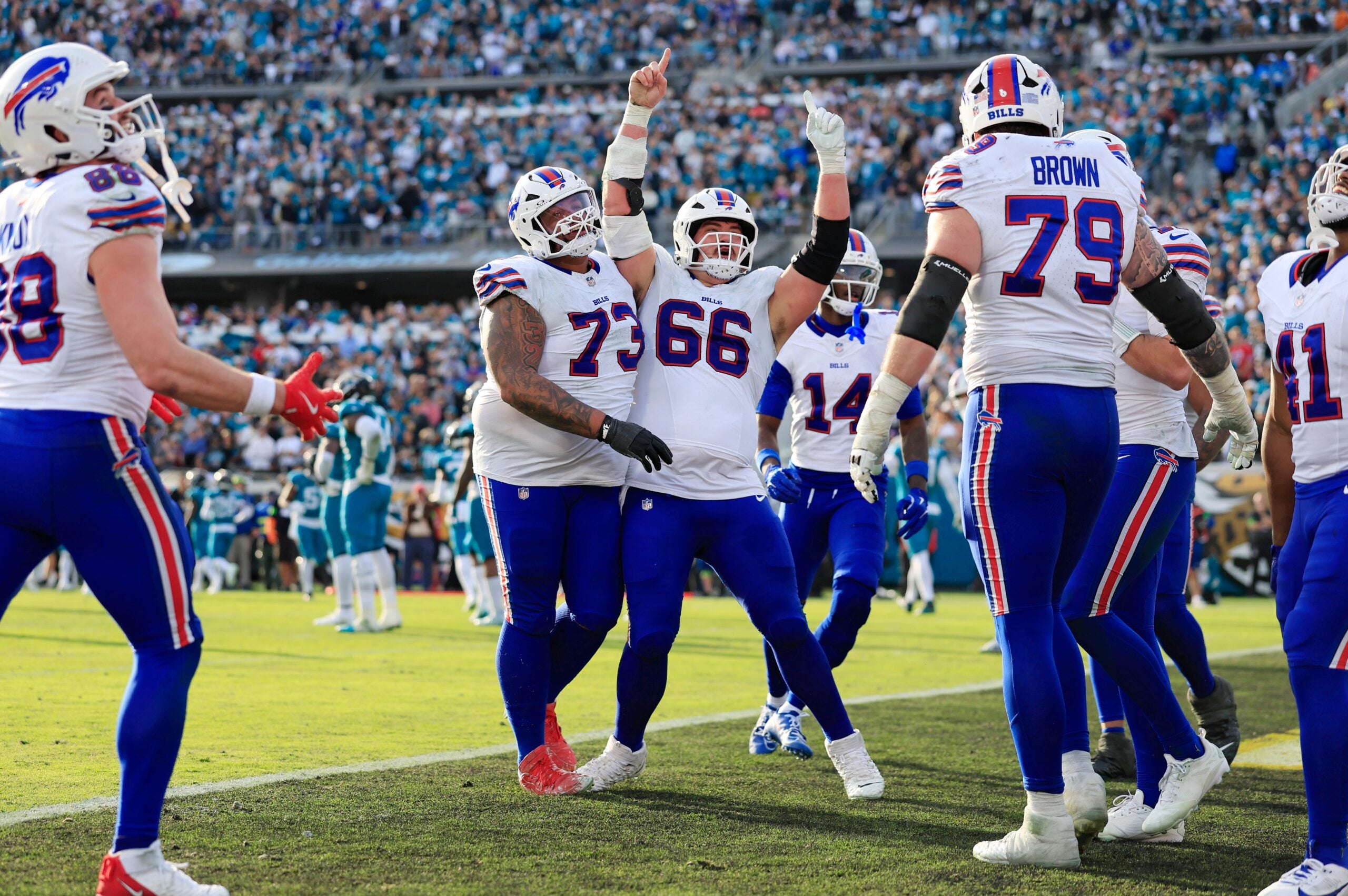 Buffalo Bills center Connor McGovern (66) celebrates a touchdown from Buffalo Bills quarterback Josh Allen (17), not shown, during the fourth quarter of an NFL football AFC Wild Card playoff matchup, Sunday, Jan. 11, 2026, in Jacksonville, Fla. The Bills defeated the Jaguars 27-24.