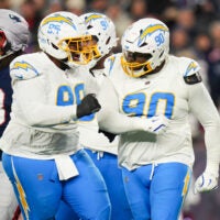 Group of chargers defenders celebrate a positive play