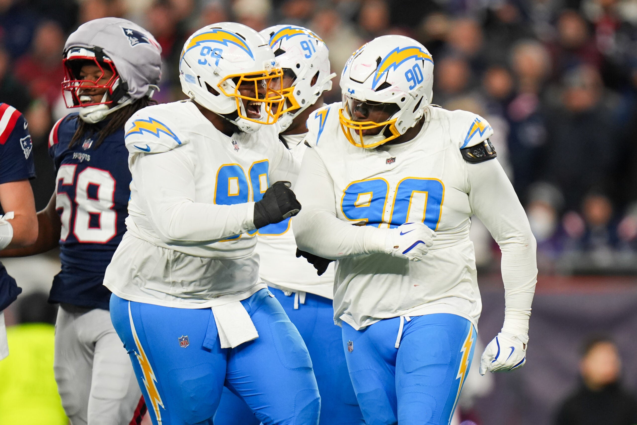 Group of chargers defenders celebrate a positive play