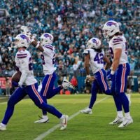 Buffalo Bills safety Cole Bishop (24), from left, celebrates his interception, sealing the game, with safety Sam Franklin Jr. (28), linebacker Dorian Williams (42) and linebacker Matt Milano (58), during the fourth quarter of an NFL football AFC Wild Card playoff matchup, Sunday, Jan. 11, 2026, in Jacksonville, Fla. The Bills defeated the Jaguars 27-24.