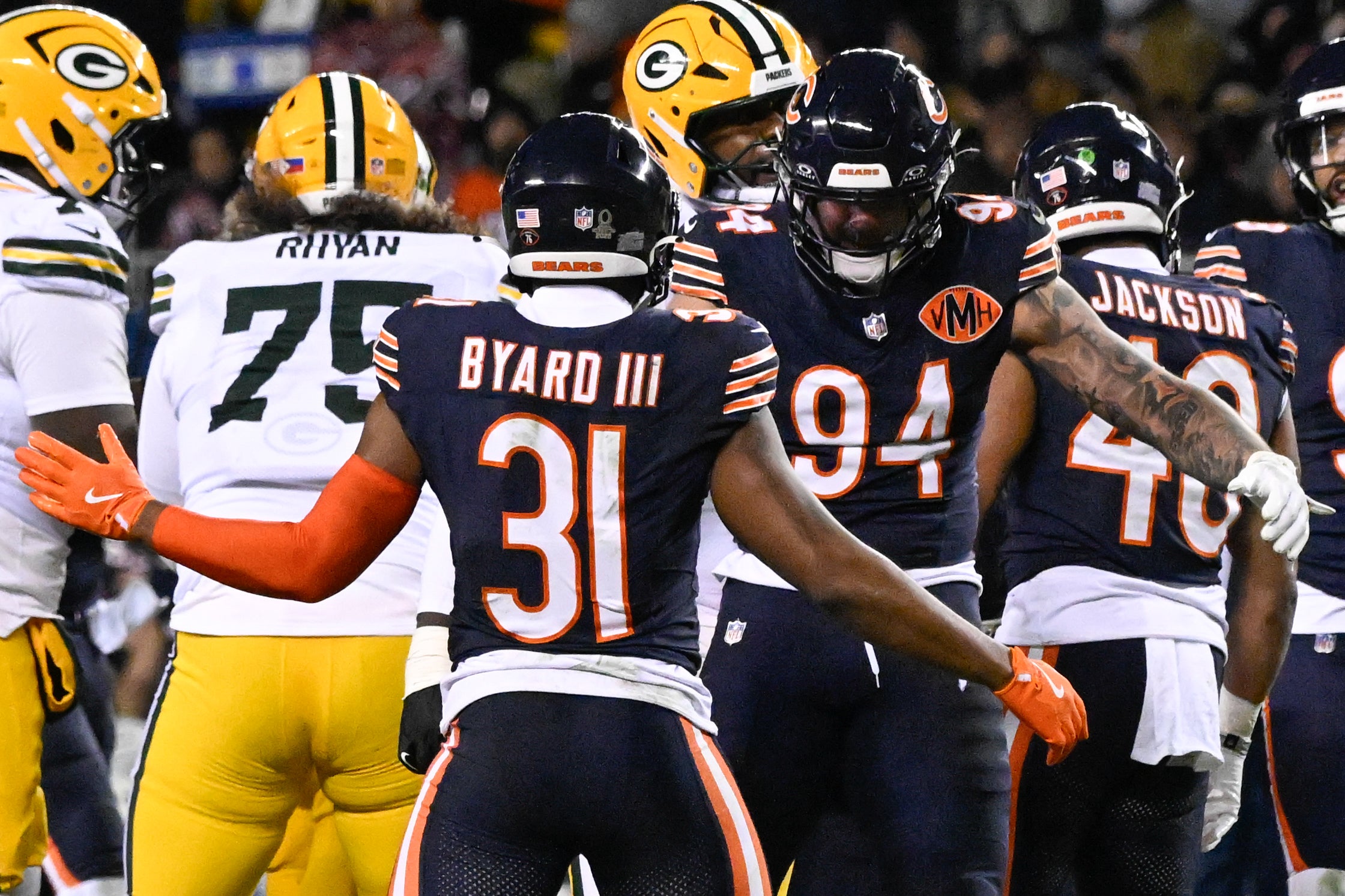 Jan 10, 2026; Chicago, IL, USA; in Chicago Bears safety Kevin Byard III (31) and defensive end Austin Booker (94) celebrate after sacking Green Bay Packers quarterback Jordan Love (10) during an NFC Wild Card Round game at Soldier Field.
