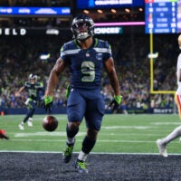 Jan 17, 2026; Seattle, WA, USA; Seattle Seahawks running back Kenneth Walker III (9) scores a touchdown against the San Francisco 49ers during the first half in an NFC Divisional Round game at Lumen Field.