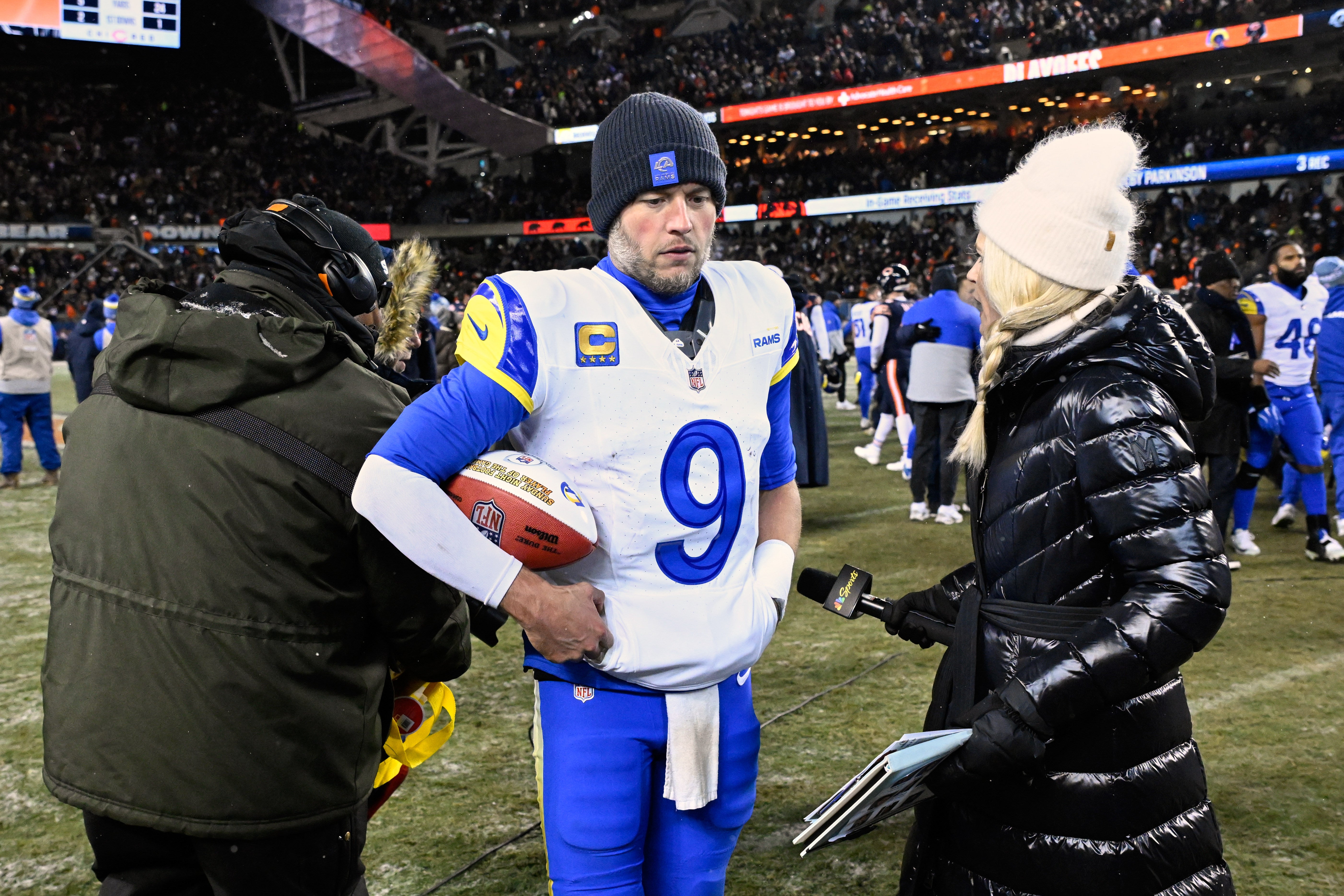 Jan 18, 2026; Chicago, IL, USA; Los Angeles Rams quarterback Matthew Stafford (9) holds a game ball as he is interviewed by NBC sideline reporter Melissa Stark after a NFC Divisional Round game against the Chicago Bears at Soldier Field.