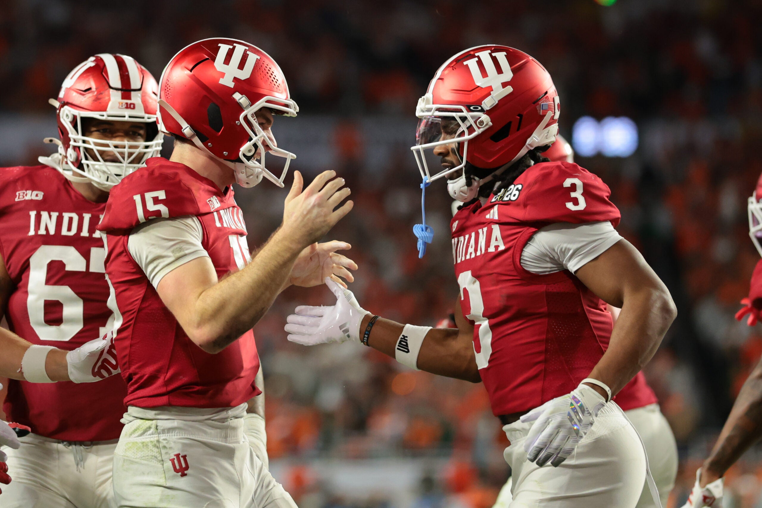 Jan 19, 2026; Miami Gardens, FL, USA; Indiana Hoosiers quarterback Fernando Mendoza (15) celebrates with wide receiver Omar Cooper Jr. (3) after scoring a touchdown against the Miami Hurricanes in the fourth quarter during the College Football Playoff National Championship game at Hard Rock Stadium. Mandatory Credit: Sam Navarro-Imagn Images