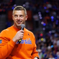 Jan 24, 2026; Gainesville, Florida, USA; Florida Gators Football head coach Jon Sumrall addresses the crowd during a timeout against the Auburn Tigers during the first half at Exactech Arena at the Stephen C. O'Connell Center.