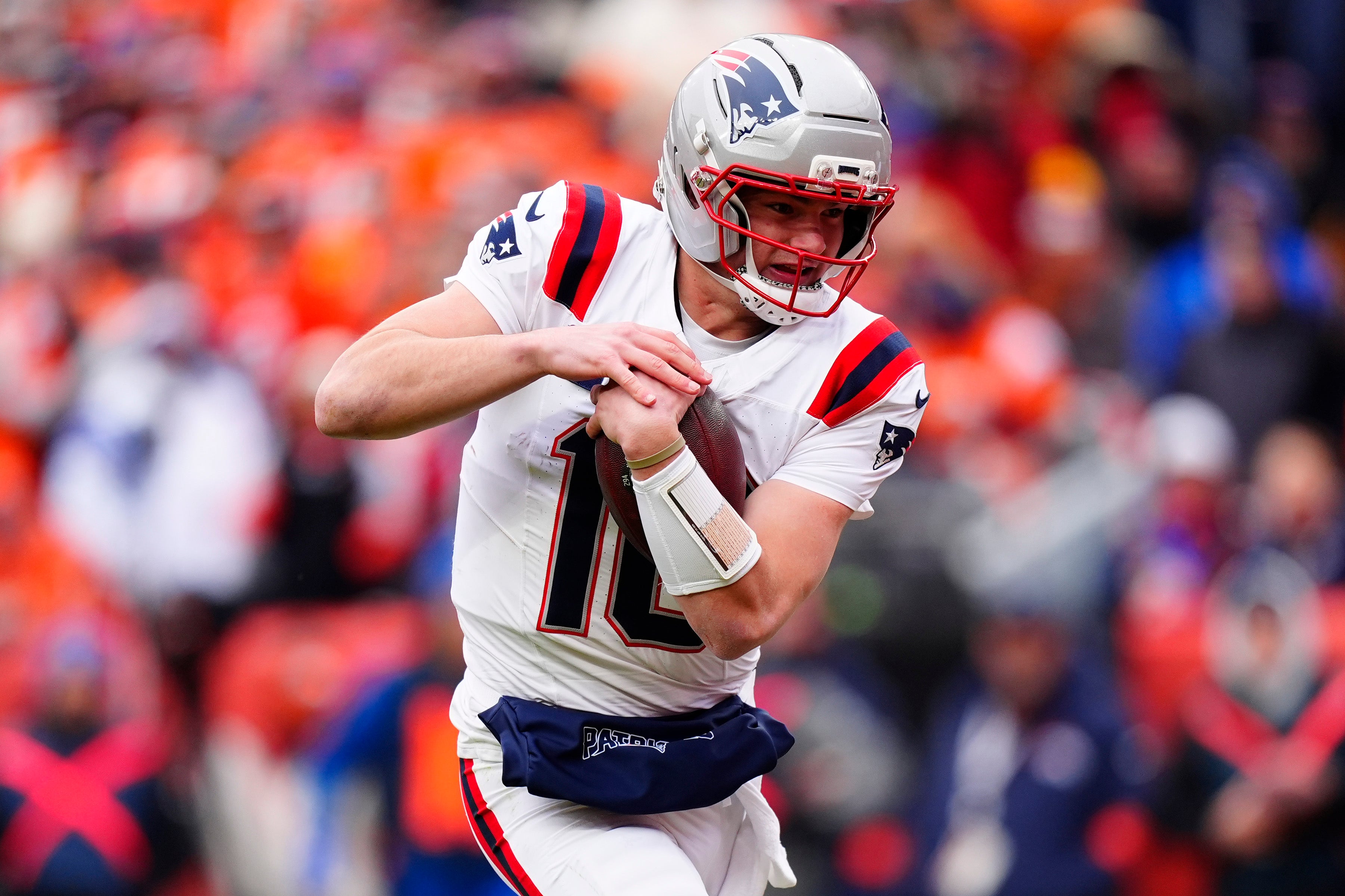 Jan 25, 2026; Denver, CO, USA; New England Patriots quarterback Drake Maye (10) rushes the ball for a touchdown against the Denver Broncos during the first half in the 2026 AFC Championship Game at Empower Field at Mile High