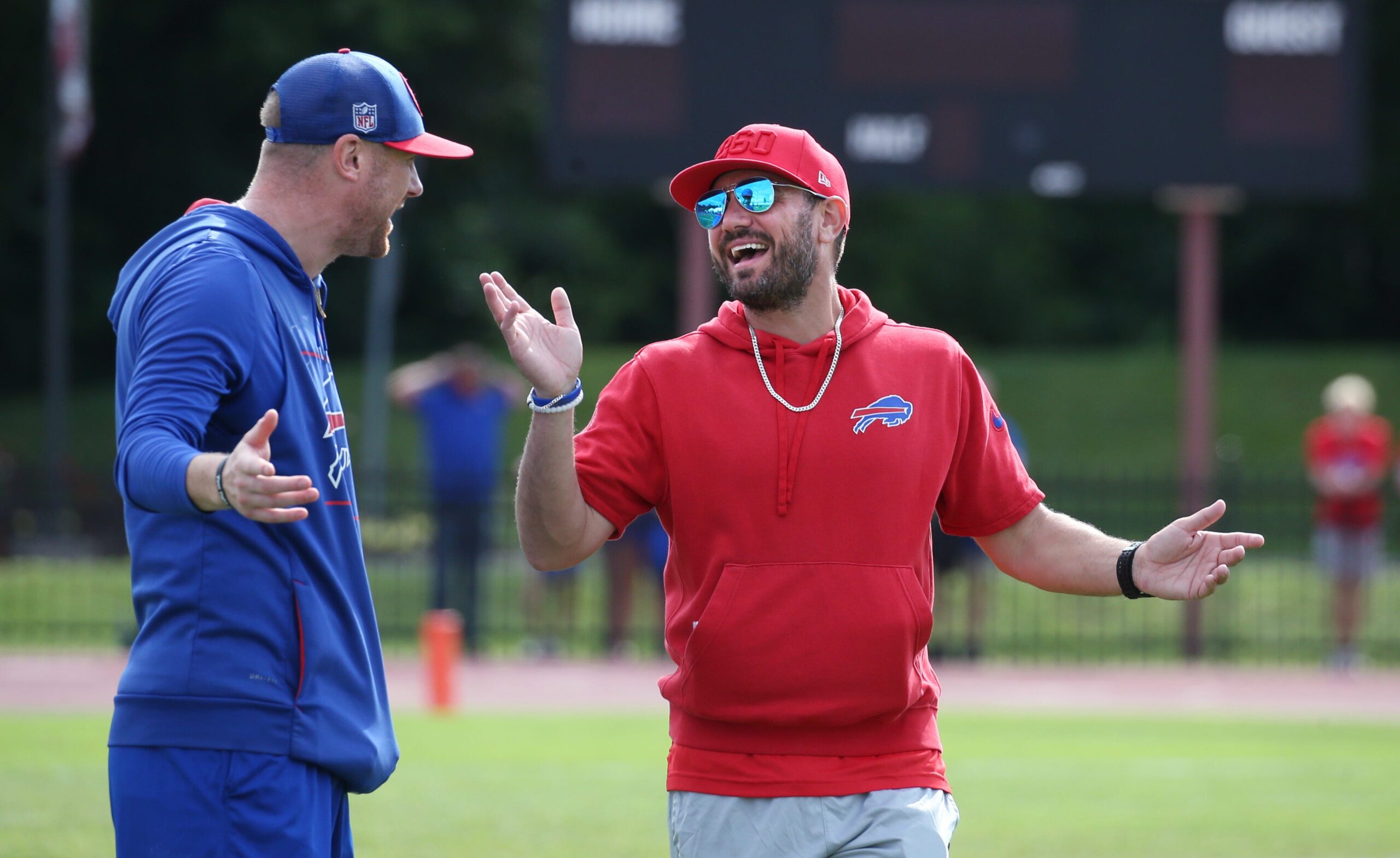 Bills offensive coordinator Joe Brady, left, and defensive coordinator Bobby Babich talk before the start of the final Buffalo Bills training camp session.