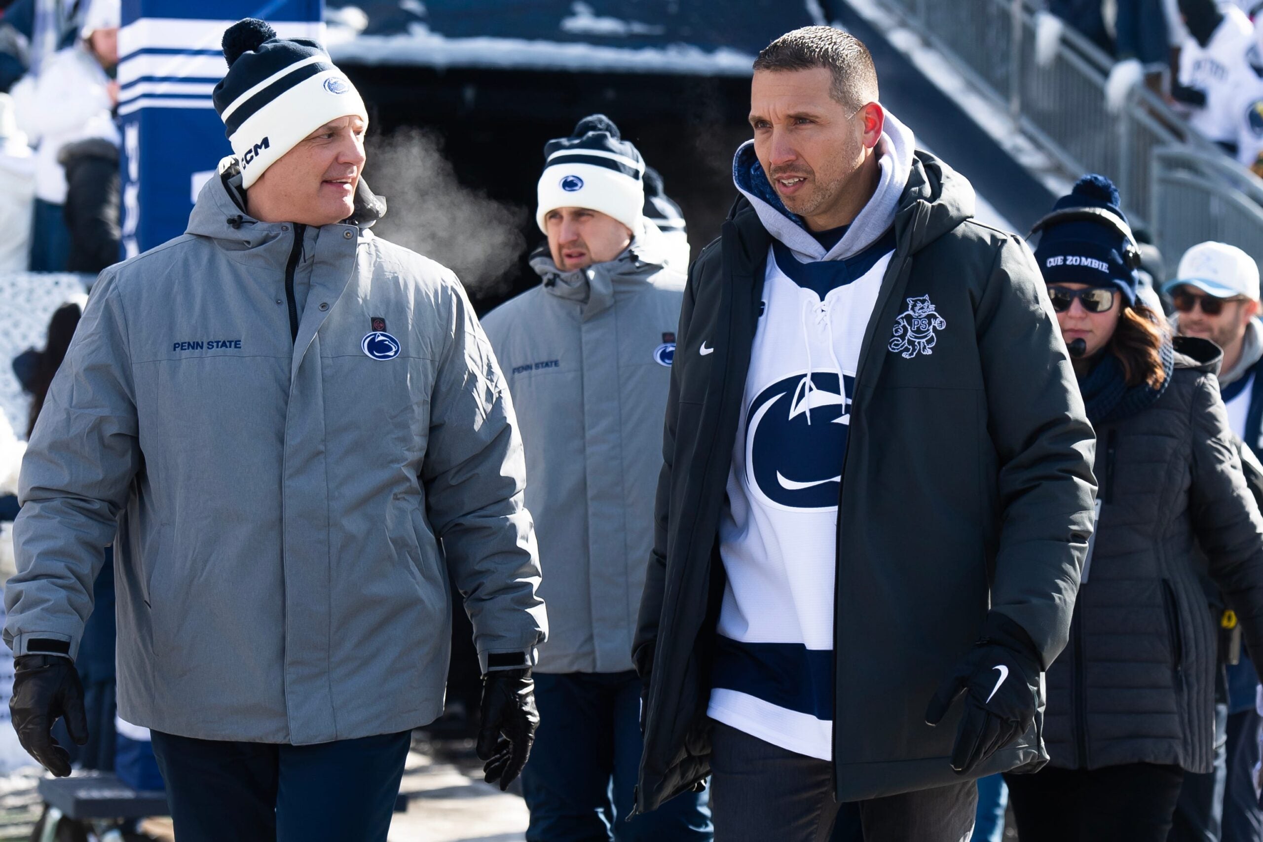 First-year Penn State football head coach Matt Campbell, right, walks into Beaver Stadium for a top-five Big Ten ice hockey game against Michigan State in Beaver Stadium on January 31, 2026, in State College.