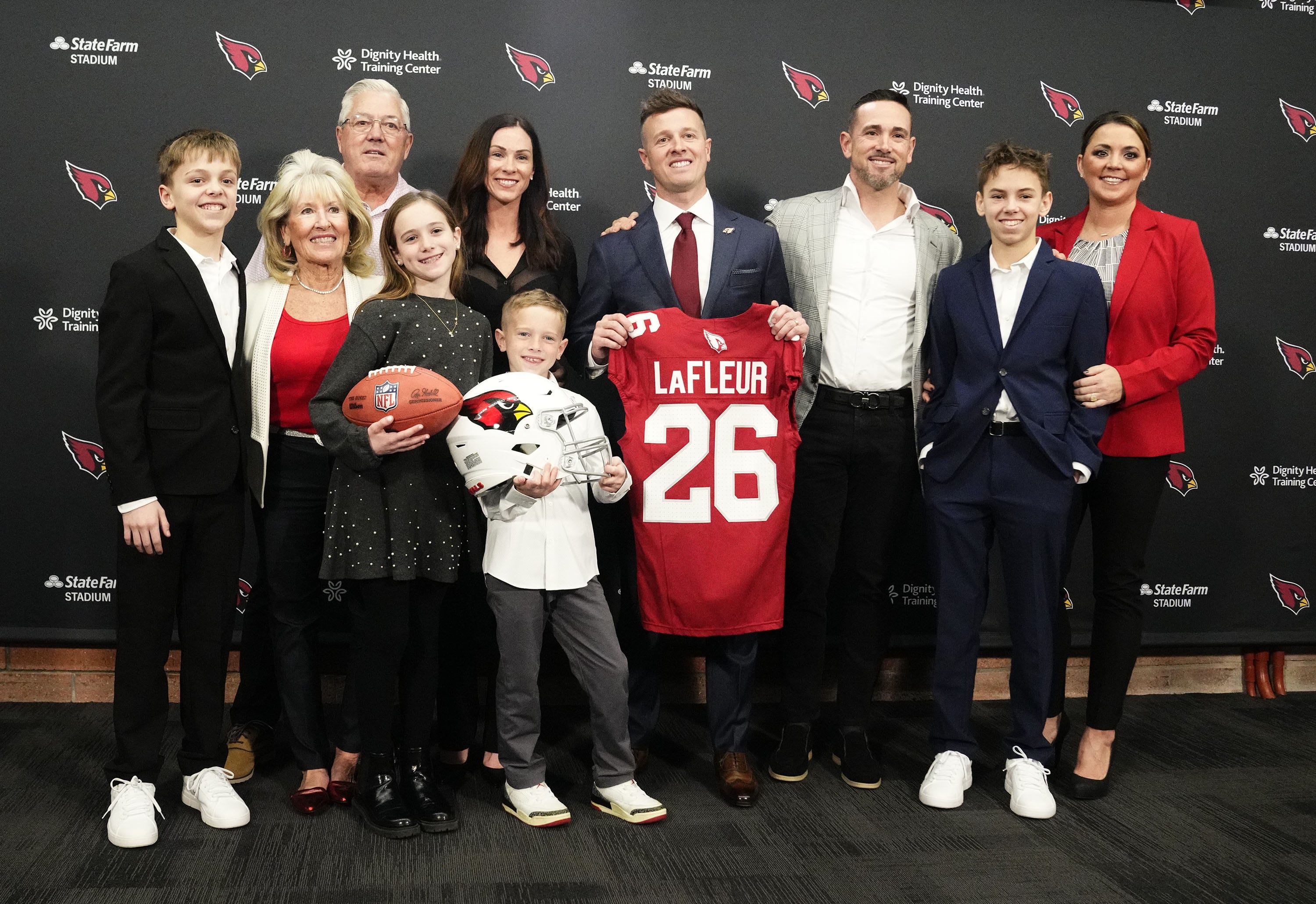 Arizona Cardinals new coach head Mike LaFleur poses with his Family, including Packers HC Matt LaFleur, during a news conference on Feb. 3, 2026, at Arizona Cardinals training center in Tempe.