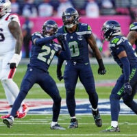 Feb 8, 2026; Santa Clara, CA, USA; Seattle Seahawks defensive end DeMarcus Lawrence (0) and Seattle Seahawks cornerback Devon Witherspoon (21) react after a play during the first quarter against the New England Patriots in Super Bowl LX at Levi's Stadium.