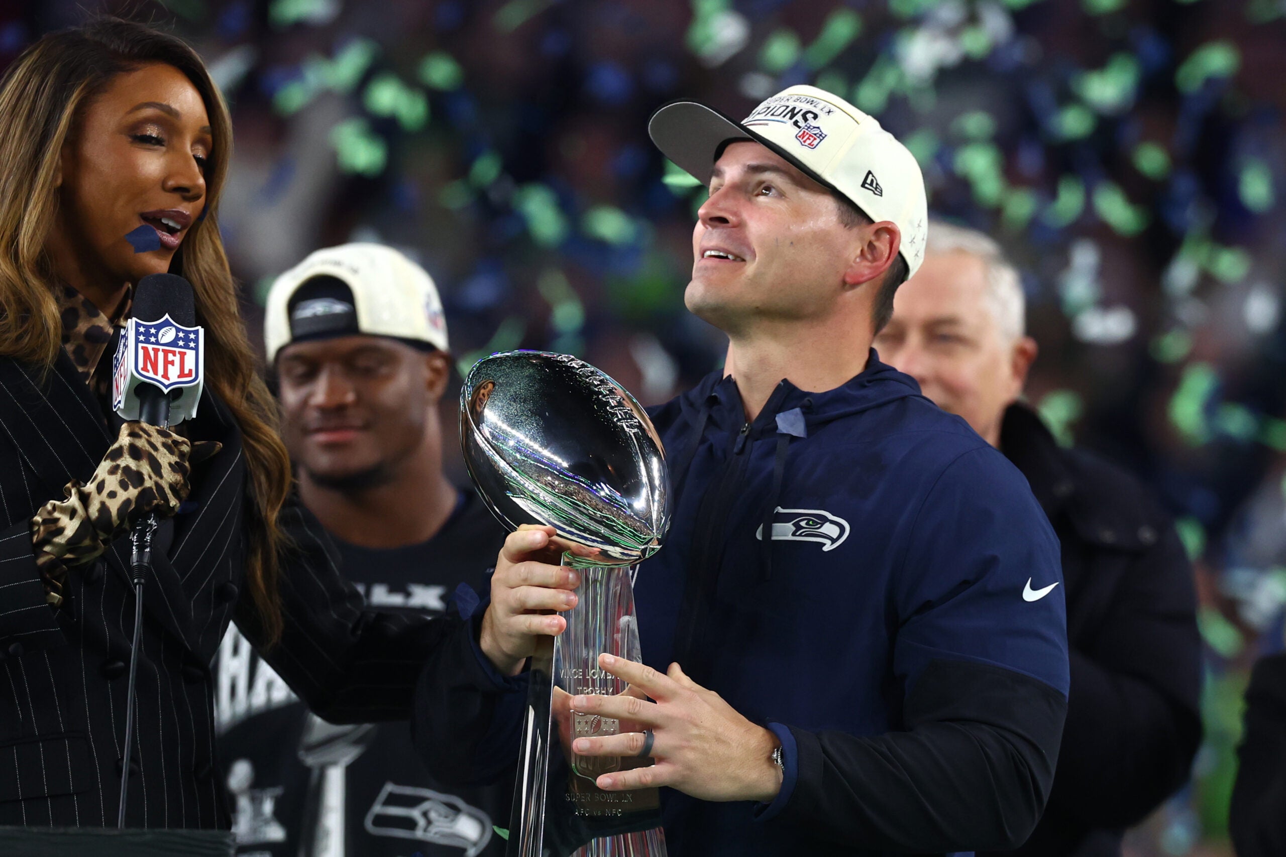 Feb 8, 2026; Santa Clara, CA, USA; Seattle Seahawks head coach Mike MacDonald celebrates with the Vince Lombardi trophy on the podium after defeating the New England Patriots in Super Bowl LX at Levi's Stadium.