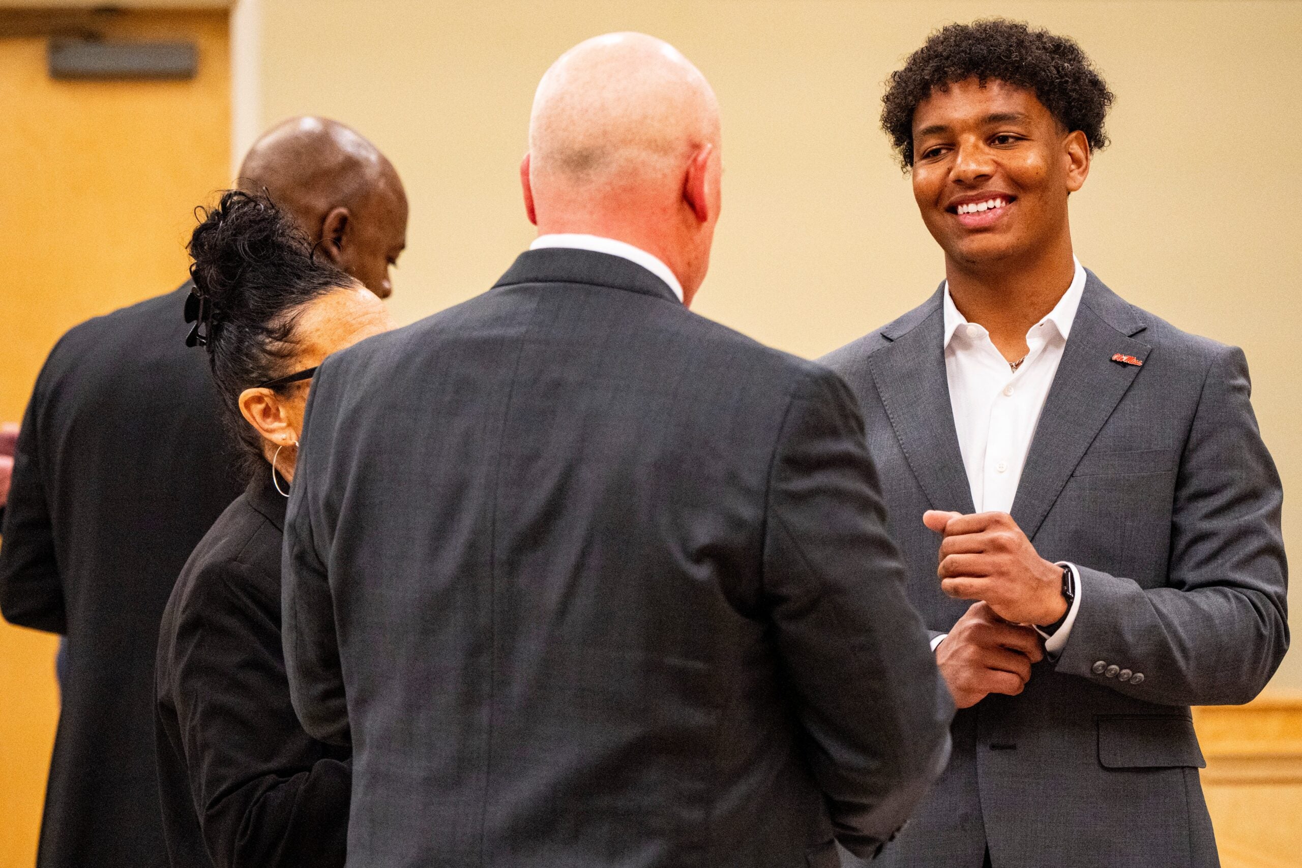 Ole Miss quarterback Trinidad Chambliss smiles while talking with his attorney William Liston during the hearing of Chambliss in his lawsuit against the NCAA at Calhoun County Courthouse in Pittsboro, Miss., on Thursday, Feb. 12, 2026. Chambliss is looking for a temporary injunction and a permanent injunction against the NCAA for one more year of eligibility.