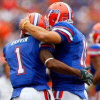 October 25, 2008; Gainesville FL, USA; Florida Gators quarterback Tim Tebow (15) hugs Florida Gators receiver Percy Harvin (1) after he scored a touchdown during the first half against the Kentucky Wildcats at Ben Hill Griffin Stadium.