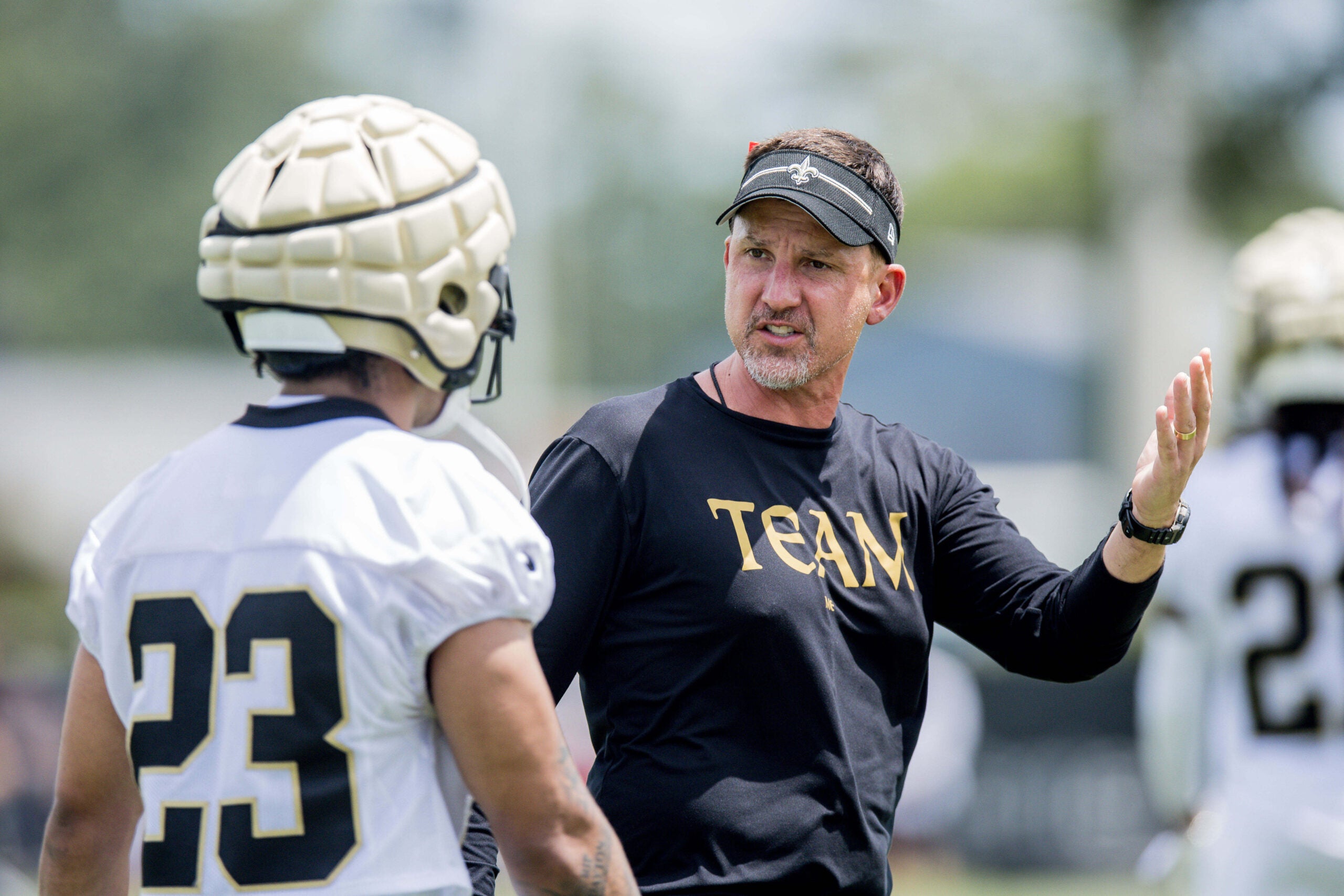 Jun 13, 2023; New Orleans, LA, USA; New Orleans Saints head coach Dennis Allen gives instruction to cornerback Marshon Lattimore (23) during minicamp at the Ochsner Sports Performance Center.