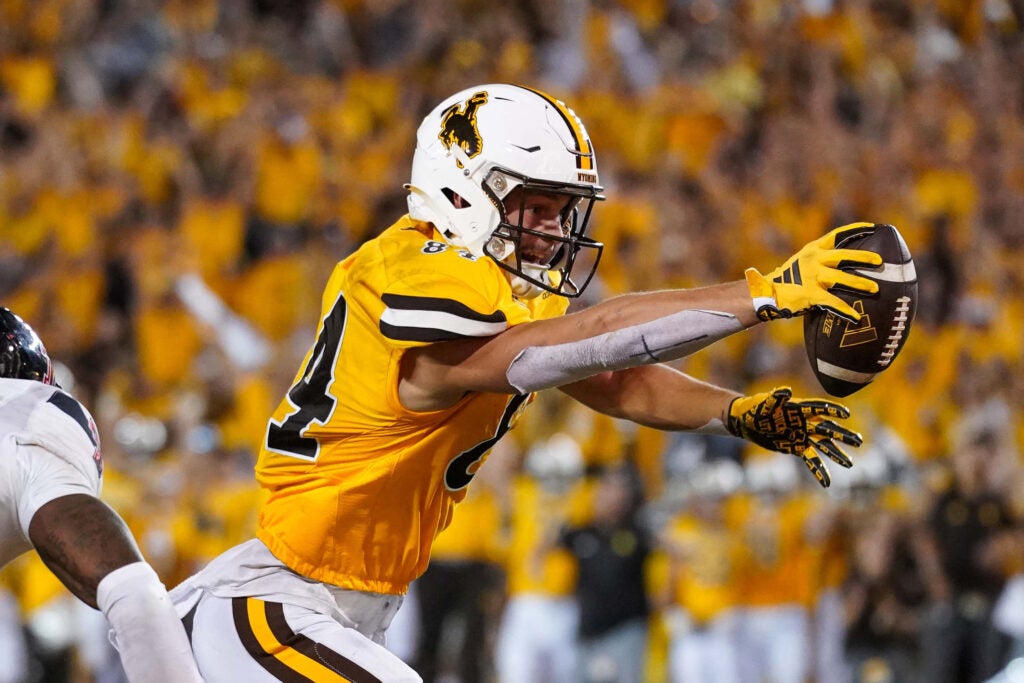 Sep 2, 2023; Laramie, Wyoming, USA; Wyoming Cowboys tight end John Michael Gyllenborg (84) scores a touchdown in double overtime against the Texas Tech Red Raiders at Jonah Field at War Memorial Stadium. 