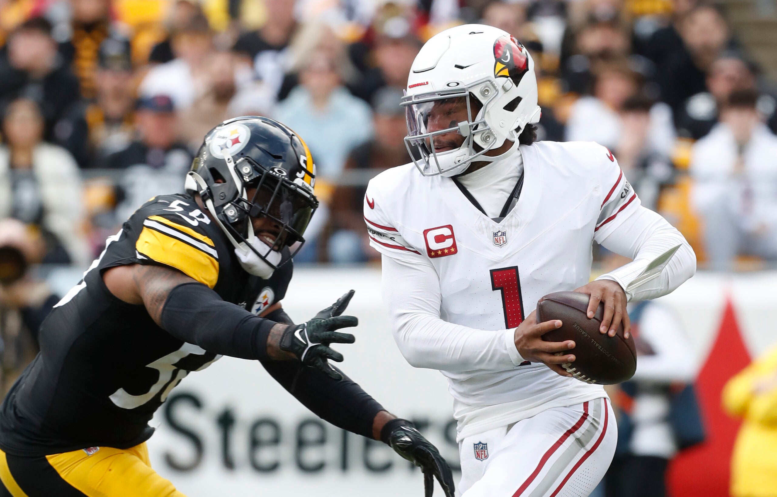 Dec 3, 2023; Pittsburgh, Pennsylvania, USA; Arizona Cardinals quarterback Kyler Murray (1) escapes the pass rush of Pittsburgh Steelers linebacker Elandon Roberts (50) during the first quarter at Acrisure Stadium.