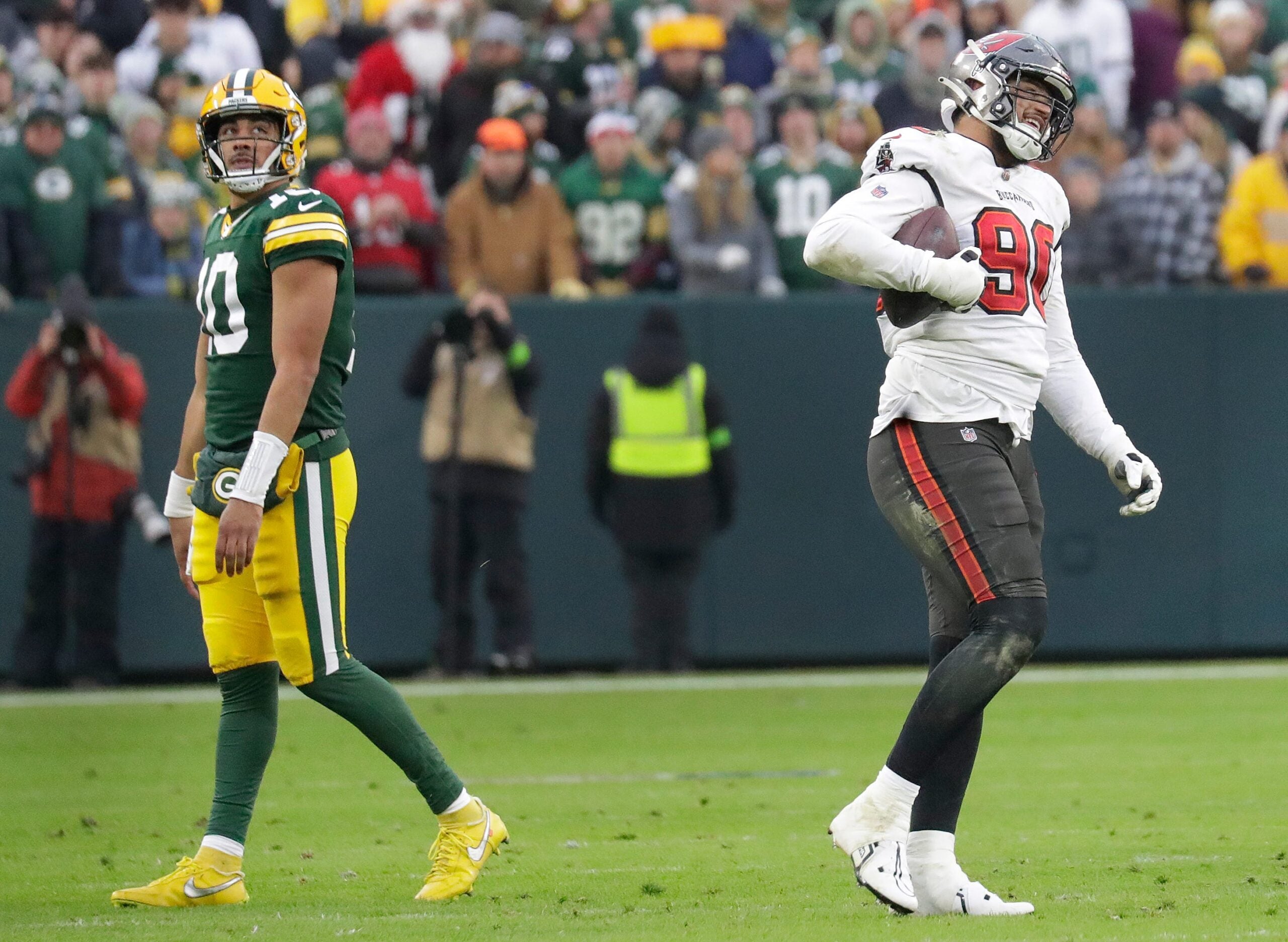 Tampa Bay Buccaneers defensive end Logan Hall (90) smiles as he walks off the field after recovering a fumble by Green Bay Packers quarterback Jordan Love (10) late in the fourth quarter during their football game Sunday, December 17, 2023, at Lambeau Field in Green Bay, Wis.