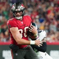 Jan 15, 2024; Tampa, Florida, USA; Tampa Bay Buccaneers tight end Cade Otton (88) breaks a tackle by Philadelphia Eagles linebacker Nicholas Morrow (41) during the first half of a 2024 NFC wild card game at Raymond James Stadium.
