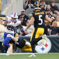 Aug 17, 2024; Pittsburgh, Pennsylvania, USA; Buffalo Bills cornerback Daequan Hardy (25) returns a punt against Pittsburgh Steelers linebacker Tyler Matakevich (44) and punter Cameron Johnston (5) during the first quarter at Acrisure Stadium.