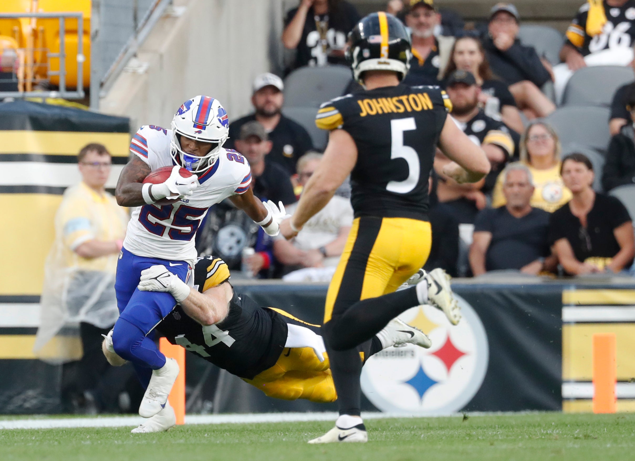 Aug 17, 2024; Pittsburgh, Pennsylvania, USA; Buffalo Bills cornerback Daequan Hardy (25) returns a punt against Pittsburgh Steelers linebacker Tyler Matakevich (44) and punter Cameron Johnston (5) during the first quarter at Acrisure Stadium.