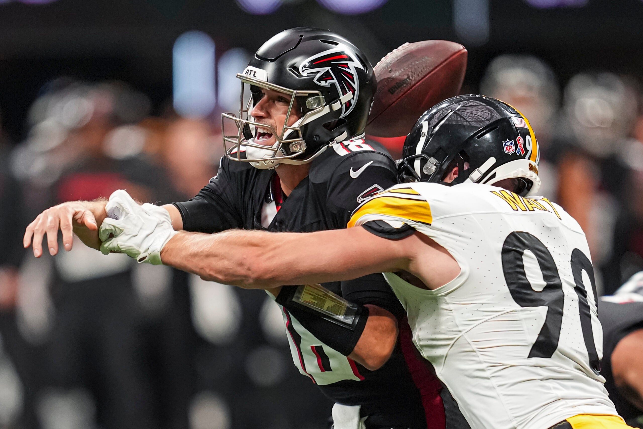 Sep 8, 2024; Atlanta, Georgia, USA; Pittsburgh Steelers linebacker T.J. Watt (90) strips the ball from Atlanta Falcons quarterback Kirk Cousins (18) at Mercedes-Benz Stadium.