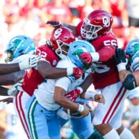 Sep 14, 2024; Norman, Oklahoma, USA; Oklahoma Sooners defensive lineman R Mason Thomas (32) and defensive lineman Gracen Halton (56) sack Tulane Green Wave quarterback Darian Mensah (10) during the second half at Gaylord Family-Oklahoma Memorial Stadium.
