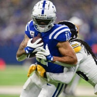 Sep 29, 2024; Indianapolis, Indiana, USA; Indianapolis Colts wide receiver Michael Pittman Jr. (11) is tackled by Pittsburgh Steelers cornerback Donte Jackson (26) during the second quarter at Lucas Oil Stadium.