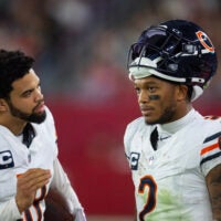 Nov 3, 2024; Glendale, Arizona, USA; Chicago Bears quarterback Caleb Williams (18) talks with wide receiver DJ Moore (2) against the Arizona Cardinals at State Farm Stadium.