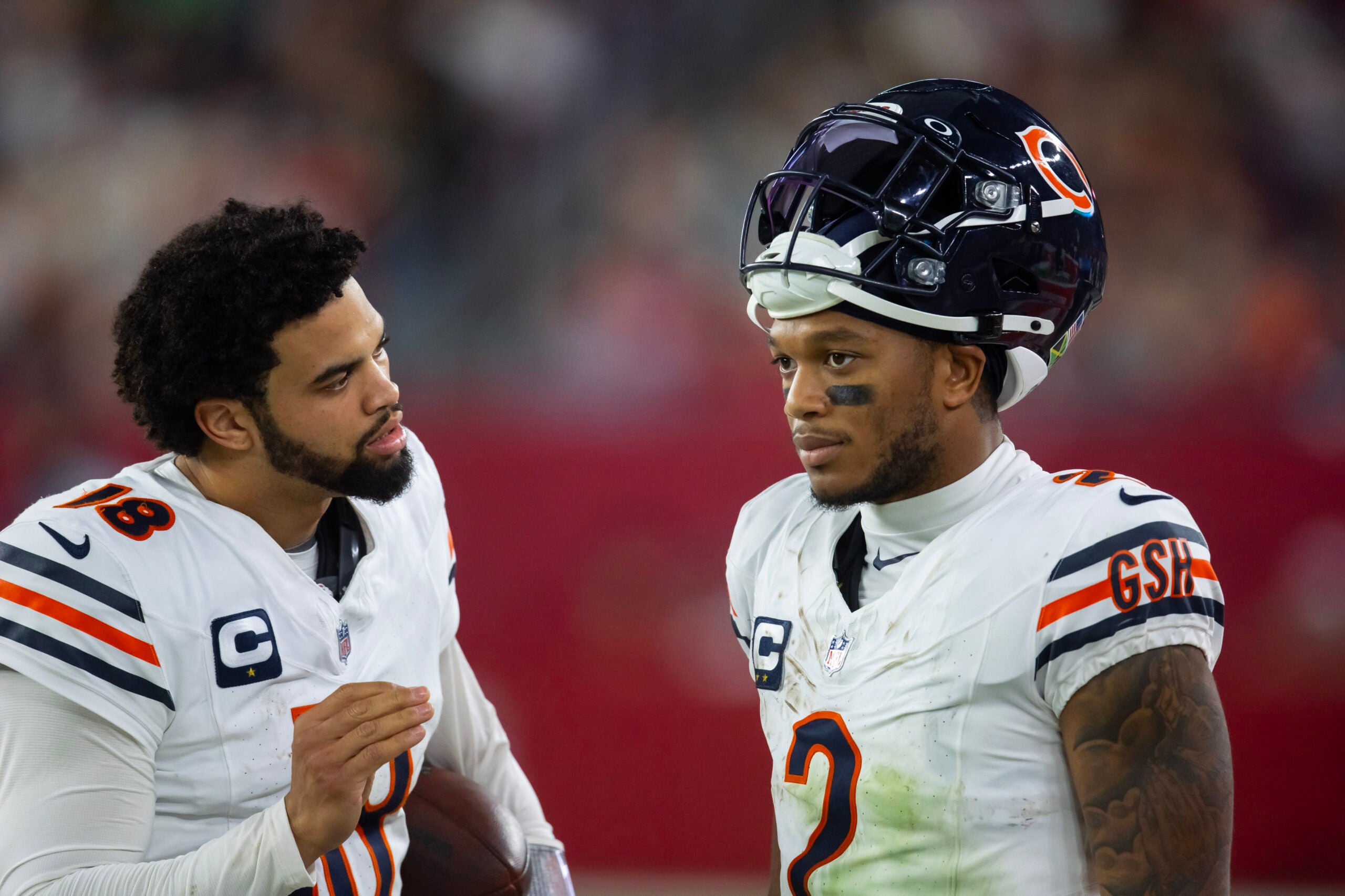 Nov 3, 2024; Glendale, Arizona, USA; Chicago Bears quarterback Caleb Williams (18) talks with wide receiver DJ Moore (2) against the Arizona Cardinals at State Farm Stadium.