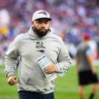 Dec 15, 2024; Glendale, Arizona, USA; New England Patriots quarterback coach T.C. McCartney against the Arizona Cardinals at State Farm Stadium. Mandatory Credit: Mark J. Rebilas-Imagn Images