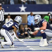 Jan 5, 2025; Arlington, Texas, USA; Dallas Cowboys running back Rico Dowdle (23) celebrates with Dallas Cowboys center Brock Hoffman (67) after scoring a touchdown during the second half against the Washington Commanders at AT&T Stadium.