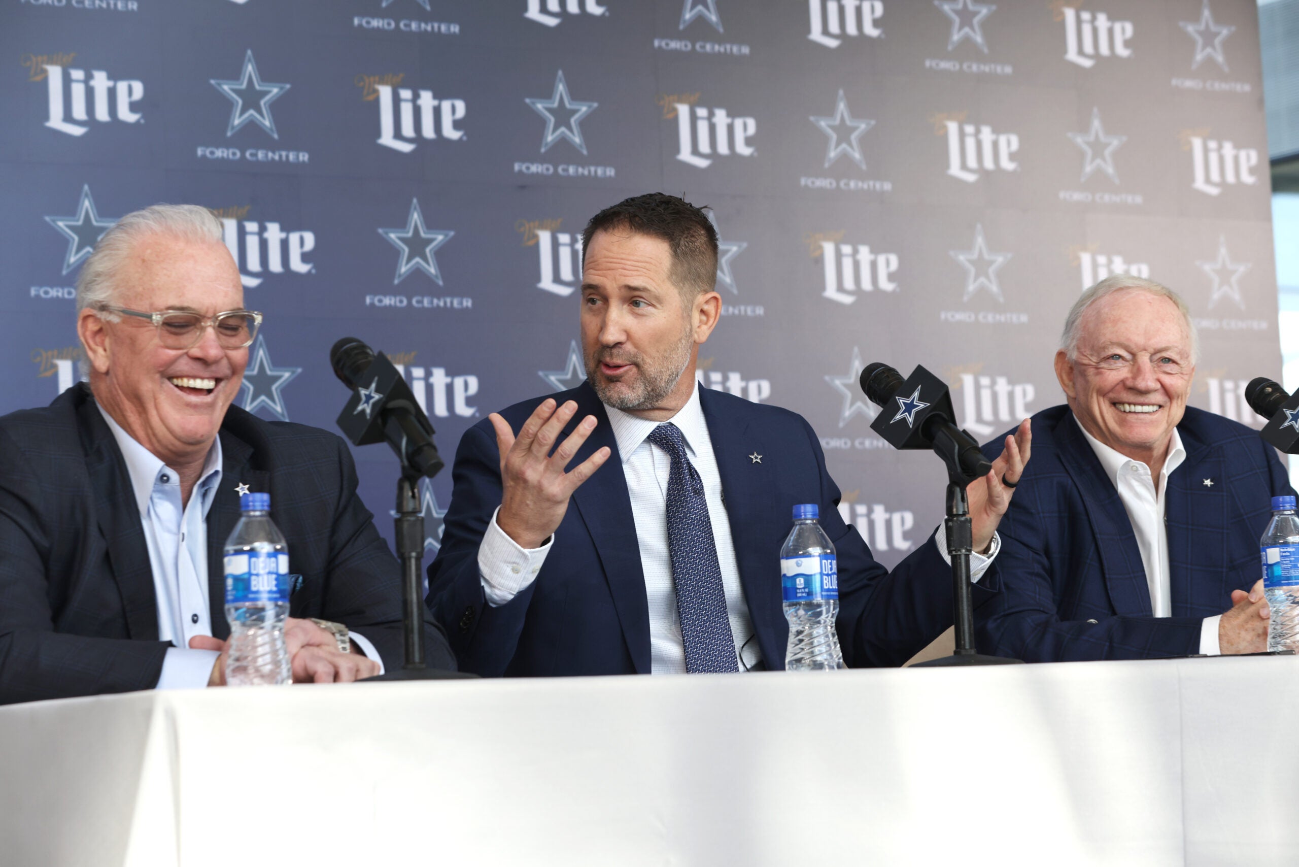 Jan 27, 2025; Frisco, TX, USA; (L to R) Dallas Cowboys CEO Stephen Jones, head coach Brian Schottenheimer and owner Jerry Jones speak to the media at a press conference at the Star.