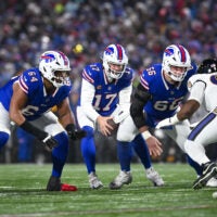 Jan 19, 2025; Orchard Park, New York, USA; Buffalo Bills quarterback Josh Allen (17) with center Connor McGovern (66) and guard O'Cyrus Torrence (64) against the Baltimore Ravens in the first quarter of a 2025 AFC divisional round game at Highmark Stadium.